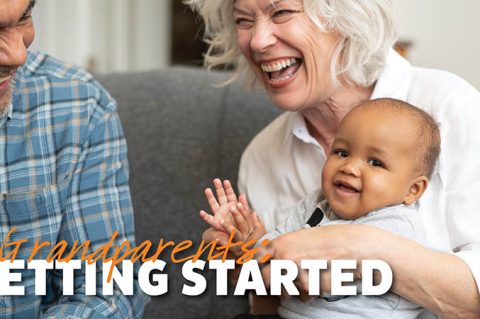 Grandparents holding baby